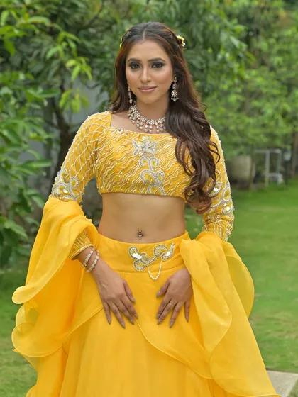 Another angle of the vibrant yellow lehenga look. The delicate polki necklace adds just the right amount of sparkle for a fresh and festive daytime celebration.