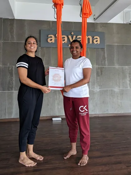 A proud moment shared between an instructor and a newly certified aerial teacher.
