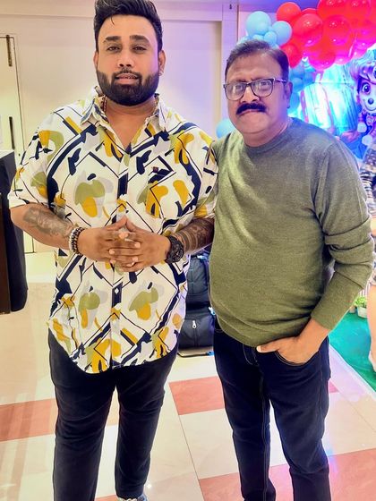 Posing with a well-known personality at a birthday event.