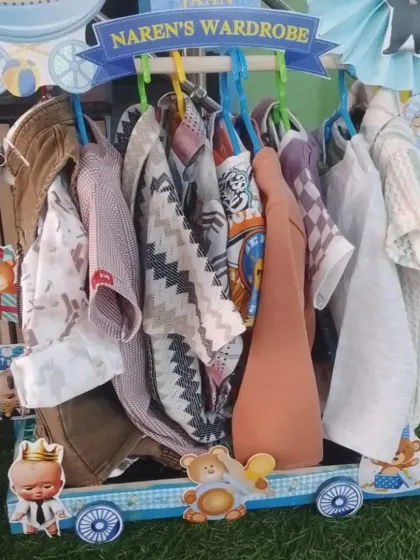 'Naren's Wardrobe' cart from a Boss Baby themed 'Nanihal Express', showing a collection of baby boy outfits.