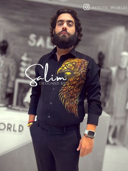 A client in a custom-designed black shirt with a hand-painted eagle head on the side. This is a more subtle way to incorporate bold artwork into your look.