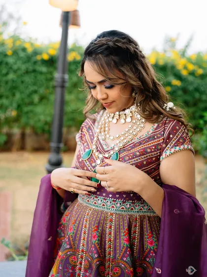A close-up of the Mehendi look. The makeup features a subtle pop of color on the eyes to complement the vibrant, multi-colored lehenga.