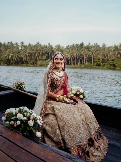 A close-up of the bride during her boat entry, radiating joy and anticipation. I ensure every detail, from the floral boat decor to the timing, is perfect for capturing these priceless expressions.