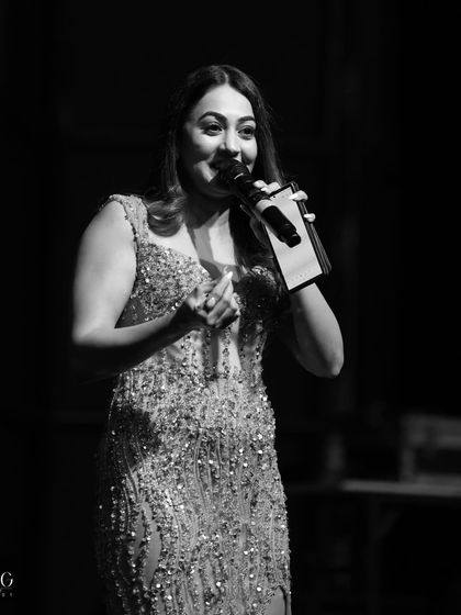A black and white shot capturing a moment of interaction during a Jaipur wedding. Even in a quiet moment, the focus is on connecting with the audience and keeping them engaged.