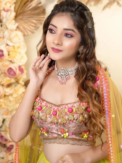 A close-up of the mesmerizing eye makeup. The pop of pink is modern and fun, perfect for a bride who isn't afraid to play with color.