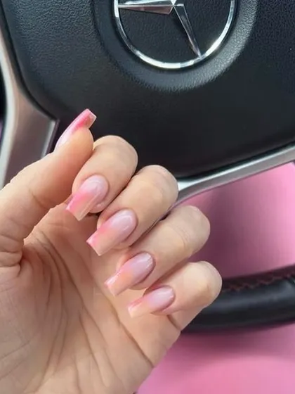 A soft pink and peach ombré on long square nails, creating a warm and delicate gradient.