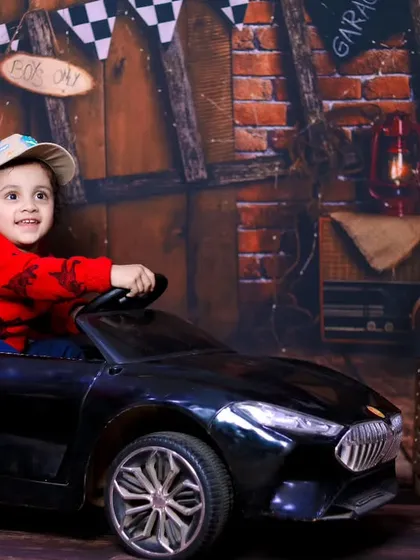 This little driver is all smiles during his car-themed photoshoot.