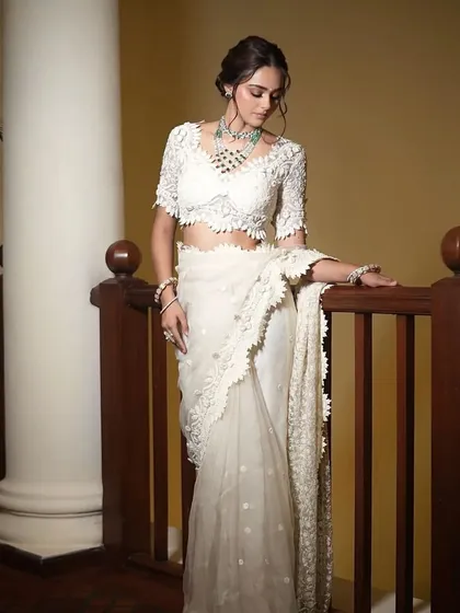 A classic pose on a staircase. The styling of this white lace saree is all about creating a look of grace and elegance.