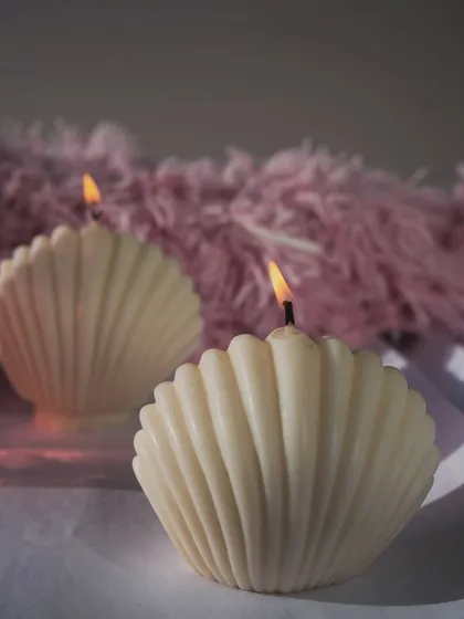 Our oyster shell candles, lit and casting a soft, warm glow. They bring a sense of peace and calm to any space.