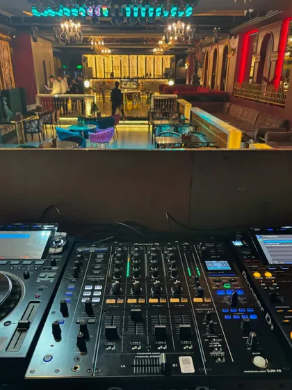 This is the command center. A view from the DJ booth we equipped with a Pioneer CDJ 3000 and DJM A9 mixer, looking out over the club. We provide DJs with the industry-standard equipment they need to perform at their best.