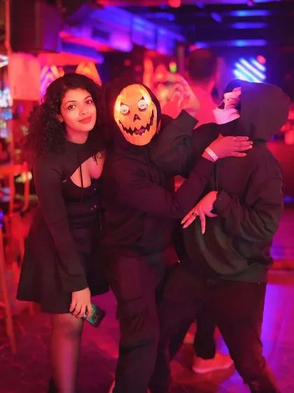 Guests in spooky masks, fully embracing the Halloween theme.