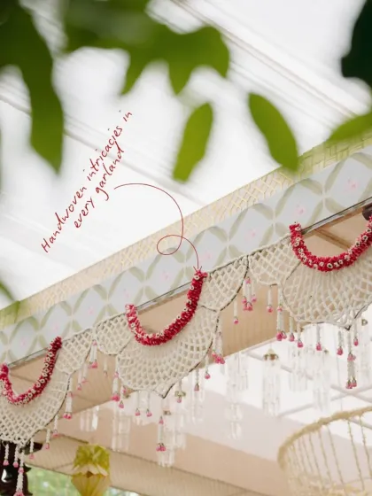 I believe in the quiet poetry of handcrafted details. For this South Indian wedding, we designed these delicate valances with handwoven petal garlands in soft pastel tones, bringing a modern, serene elegance to a cherished tradition.