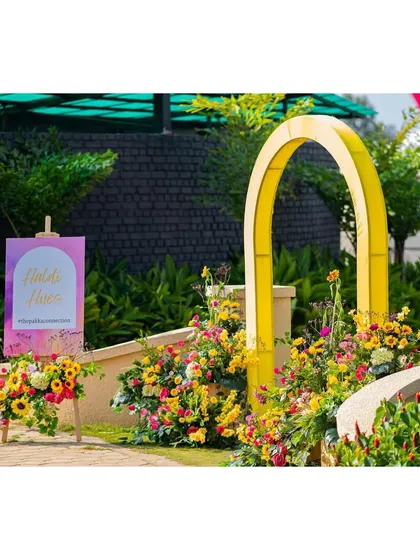 The entrance to the Haldi ceremony area, framed by a bright pink arch and a custom welcome sign.