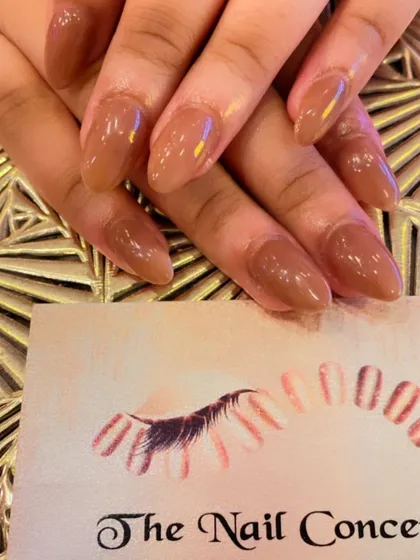 A classic set of almond-shaped nails in a warm, caramel nude color. The glossy finish gives it a polished and sophisticated look.