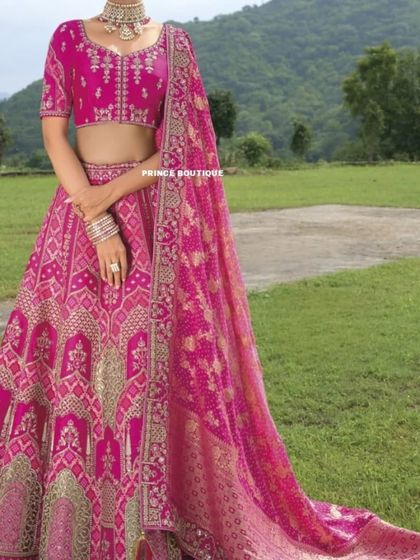 This shot shows the stunning combination of the pink lehenga with its contrasting woven dupatta, highlighting the rich textures and craftsmanship.