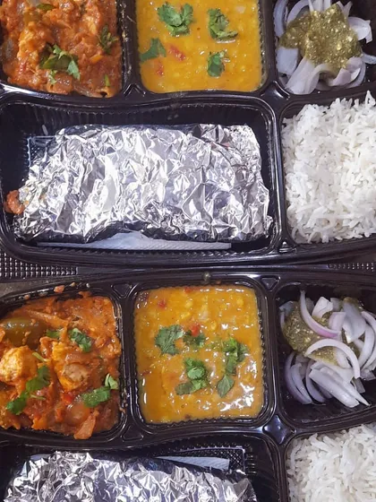 A customized order of two thalis, each with Dal Tadka and Kadai Paneer. This is a popular combination for small get-togethers.
