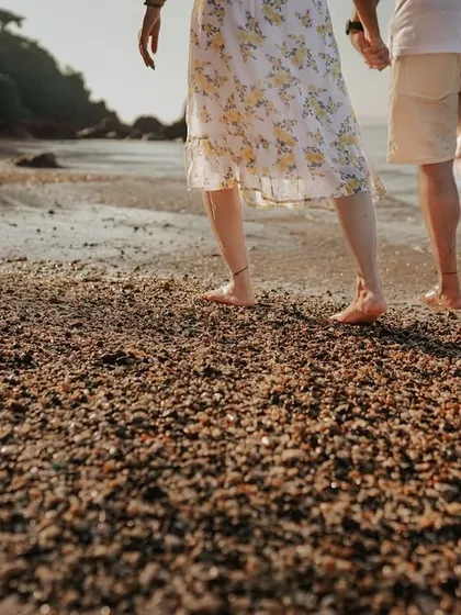 Walking hand-in-hand along the shore. This detail-oriented shot focuses on the simple act of being together, a beautiful memory from a destination pre-wedding adventure.