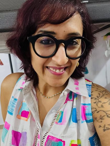 A close-up selfie showing my floral chain and the beautiful print of my dress.