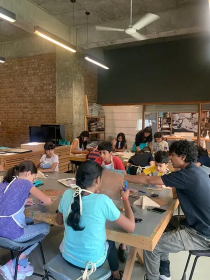 Our studio is a vibrant hub of creativity. This photo captures the collaborative and engaging atmosphere of our kids' art classes, where students work on their projects at our large communal tables with guidance from our instructors.
