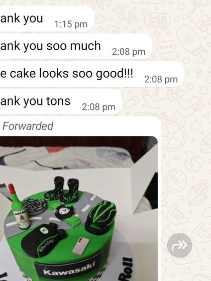 "The cake looks soo good!!!" A happy client's message after receiving their custom Kawasaki biker-themed cake.