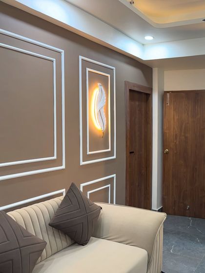 A close-up of a feature wall in a living room. I used simple POP moulding and a backlit feather art piece to create an elegant and calm corner.