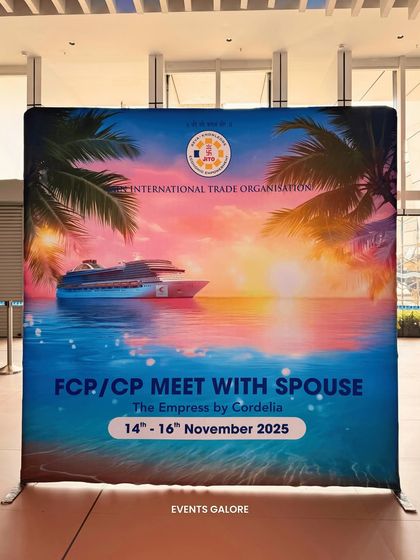 A large, branded backdrop created for the JITO family meet on the cruise. This served as the primary photo point, featuring event details and sponsor logos against a vibrant, thematic design.