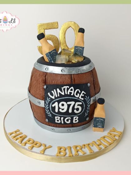 Aged to perfection! A vintage whiskey barrel cake for a 50th birthday, complete with mini Jack Daniel's bottles and an "Aged 1975" plaque.