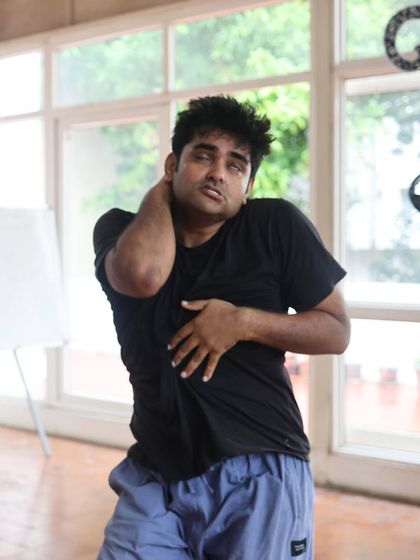 An actor stretches during a "Gretel" rehearsal.