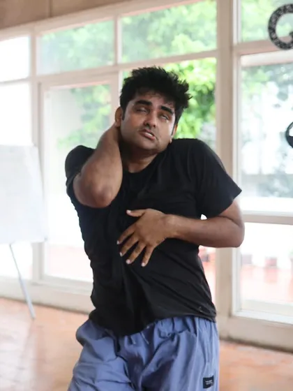 An actor stretches during a "Gretel" rehearsal.