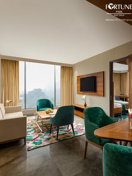 Our suites are designed to feel like a home away from home, with separate zones for relaxing and sleeping. The large windows fill the space with natural light.