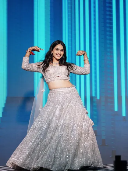The bride strikes a pose during her energetic dance number. The custom LED wall in the background was programmed to match the beat of the music.