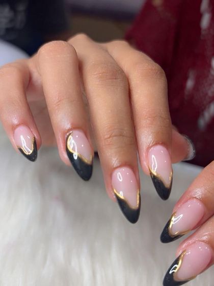 A close-up shot showing the precision of the gold chrome line work on these modern French tips.