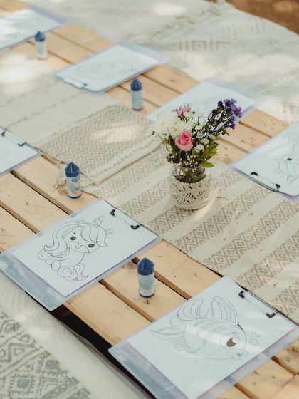 A closer look at the setup for the kids' activity table, with individual coloring stations ready for the little guests.