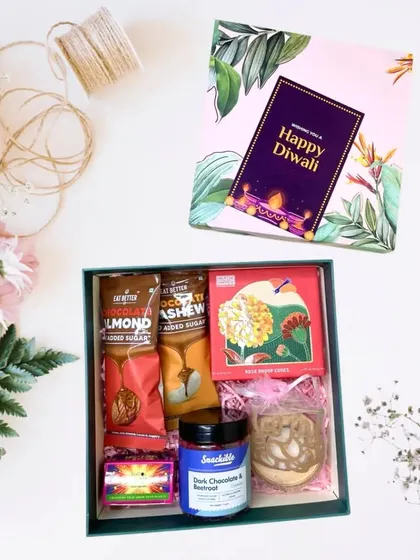 This beautifully curated hamper, starting from Rs.799, is packed in a floral-themed box. Inside, you'll find healthy treats like almond and cashew butter, dark chocolate and hazelnut dip, and assorted cookies.