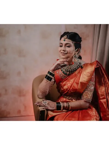 I believe every bride deserves portraits that capture her grace, or 'nazakat'. This shot focuses on the quiet moments of reflection before the ceremony, highlighting the intricate details of her traditional Maharashtrian bridal look.