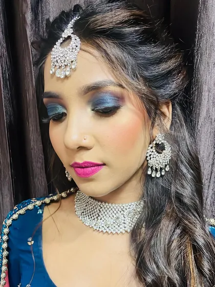 Another angle of the blue-hued reception makeup. Notice the seamless blending of the eyeshadow and the sharp definition that makes the look so impactful, a key skill we focus on in our professional makeup training.