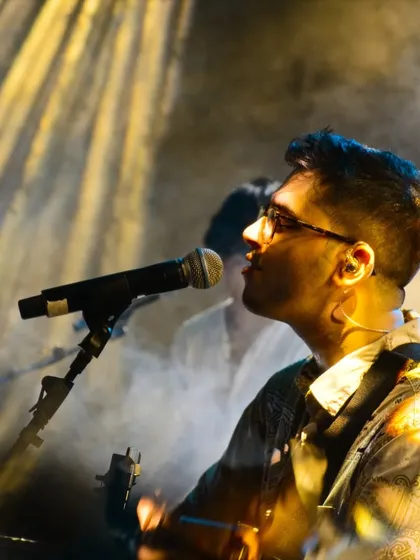 A beautiful, moody shot from our Goa performance. The combination of vocals, guitar, and stage effects creates a complete sensory experience for the audience.