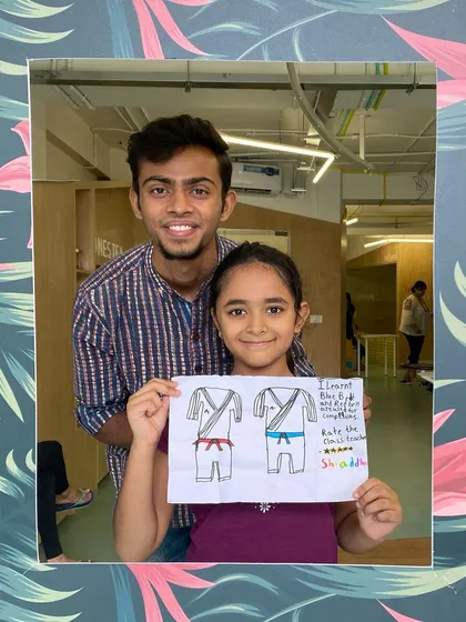 I believe in mixing martial arts with creativity. Here's one of my proud students showing off her drawing of different karate belts after a fun session. It's a great way to learn and be creative at the same time.