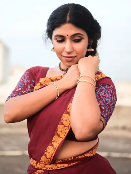 A quiet, introspective pose from a photo series discussing the role of 'aharya' or costume. Even with minimal adornment, the essence of the dancer remains. This reflects my teaching philosophy of focusing on the internal understanding of the art form, not just the external presentation.
