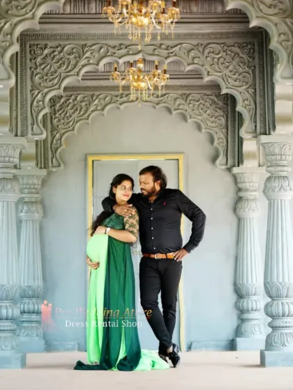 An intimate shot of a couple during their maternity shoot, with the expecting mother in our emerald and lime green gown. This rental dress is perfect for both grand, dramatic poses and quieter, close-up moments.