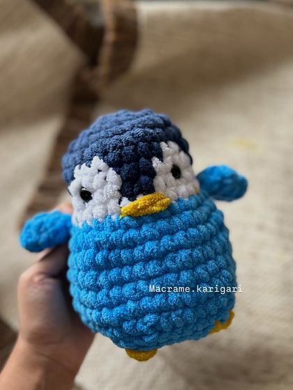 This is 'Hugsy', our chunky yarn penguin, named by one of our lovely clients. Its round, squishy shape makes it the perfect cuddle buddy.
