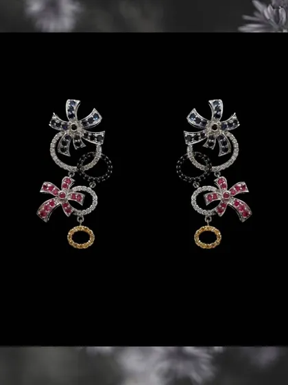 A clearer view of the multi-gemstone bow earrings. The mix of colors and shapes makes them a unique piece that will surely capture everyone's attention.