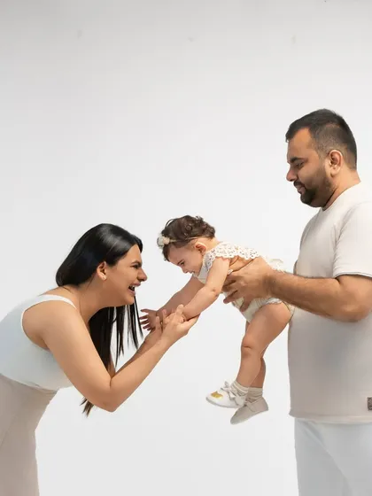 A candid shot of a family playing together in the studio. The natural laughter and interaction are what make these portraits feel so alive and authentic.