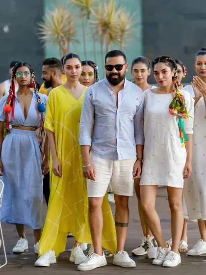 Posing with the models and fashion designer at the GETLOUD Pool Party.