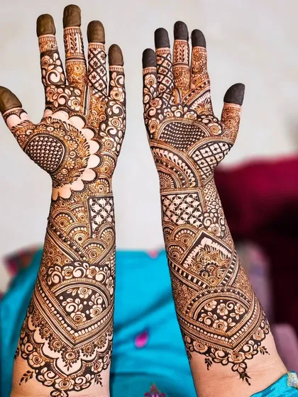 A beautiful example of asymmetrical design, where each hand tells a slightly different story while maintaining a cohesive and intricate bridal style.