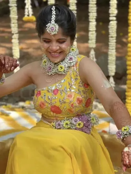 The joy of Haldi. Actress Amruta Deshmukh is all smiles, covered in turmeric and flowers, while wearing our custom floral jewellery set.