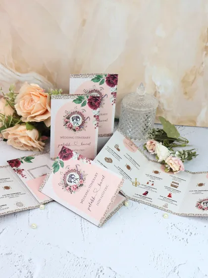 A unique wedding itinerary designed as a folded leaflet with a beautiful floral and crest design. It details the wedding events in an elegant and easy-to-read format.