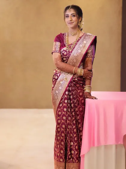 A client looking poised and elegant for an engagement party. I draped her deep wine-colored Banarasi silk saree to create a sophisticated silhouette with a neatly pleated pallu.