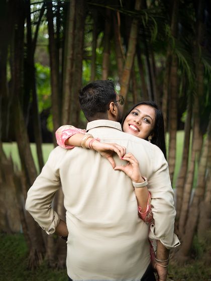 A creative and sweet pose with the bride-to-be making a heart shape with her hands around her partner. This is a great example of a fun, guided pose that feels personal.