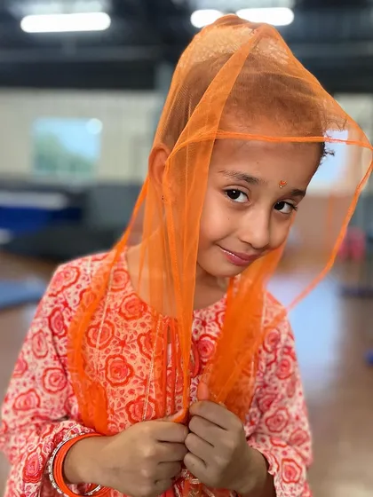 The shy charm of one of our young performers. We create a nurturing space where even the quietest students can find their confidence.